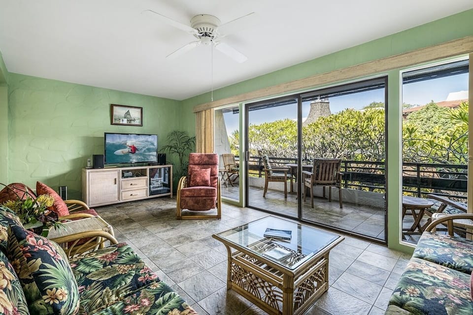 Living room at Kona oceanfront rental with two couches and chair.