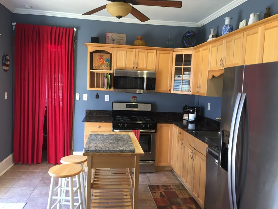 Kitchen with all new appliances, laundry room is behind the curtains