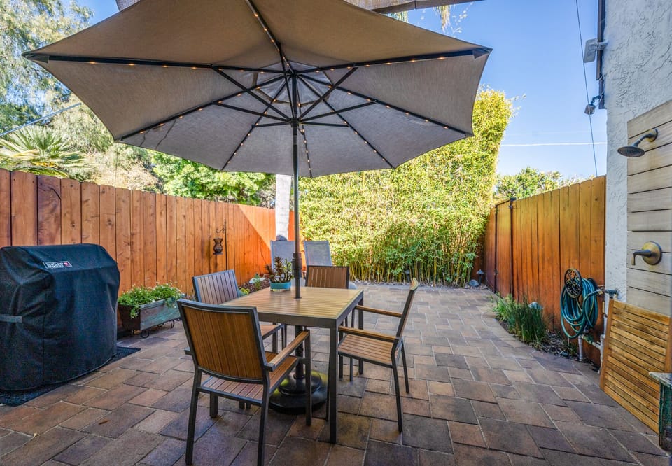Back patio has Weber barbecue, LED umbrella,  beach chairs and boogie boards