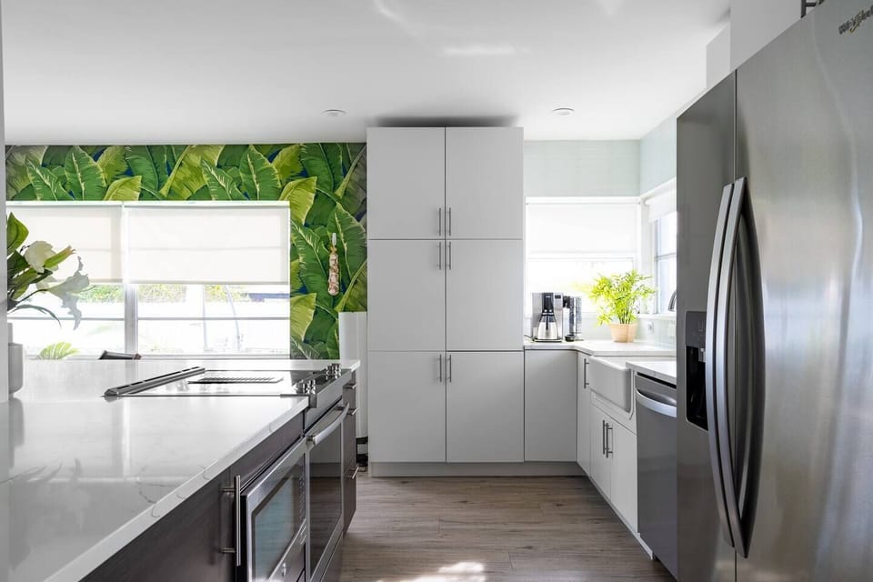 Fully-equipped kitchen with stainless appliances and quartz countertops