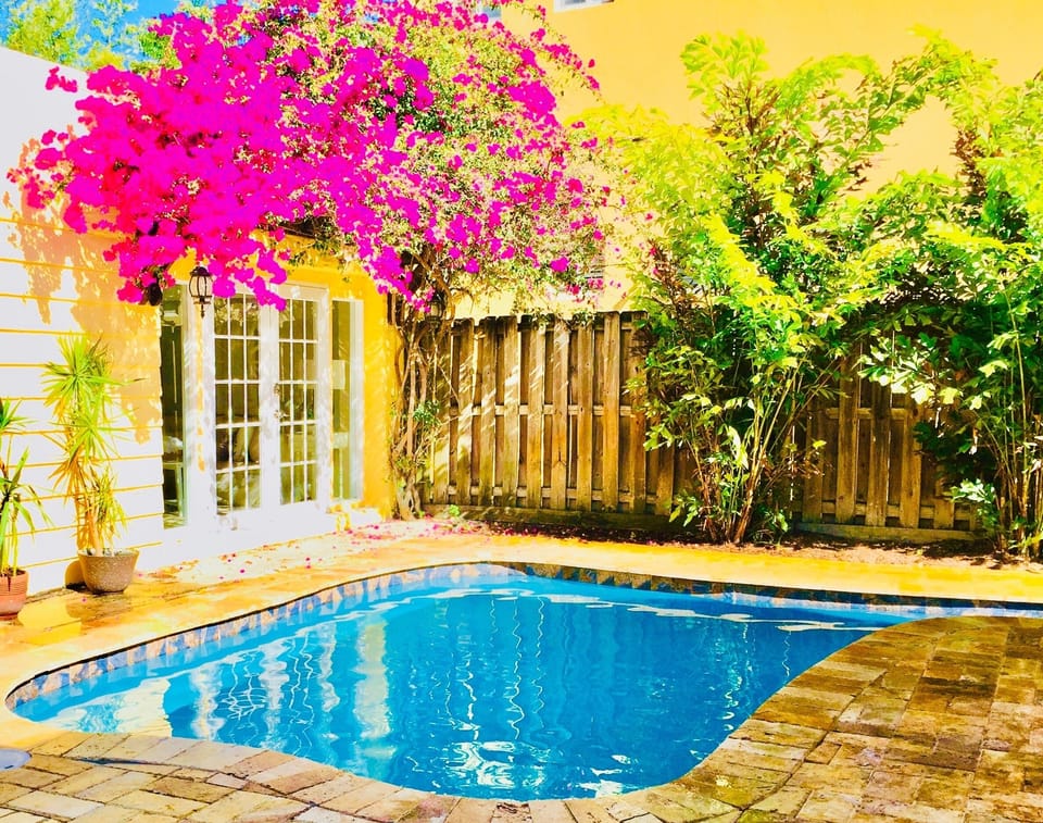 The beautiful backyard paradise has a heated pool, grill, & outdoor dining area.
