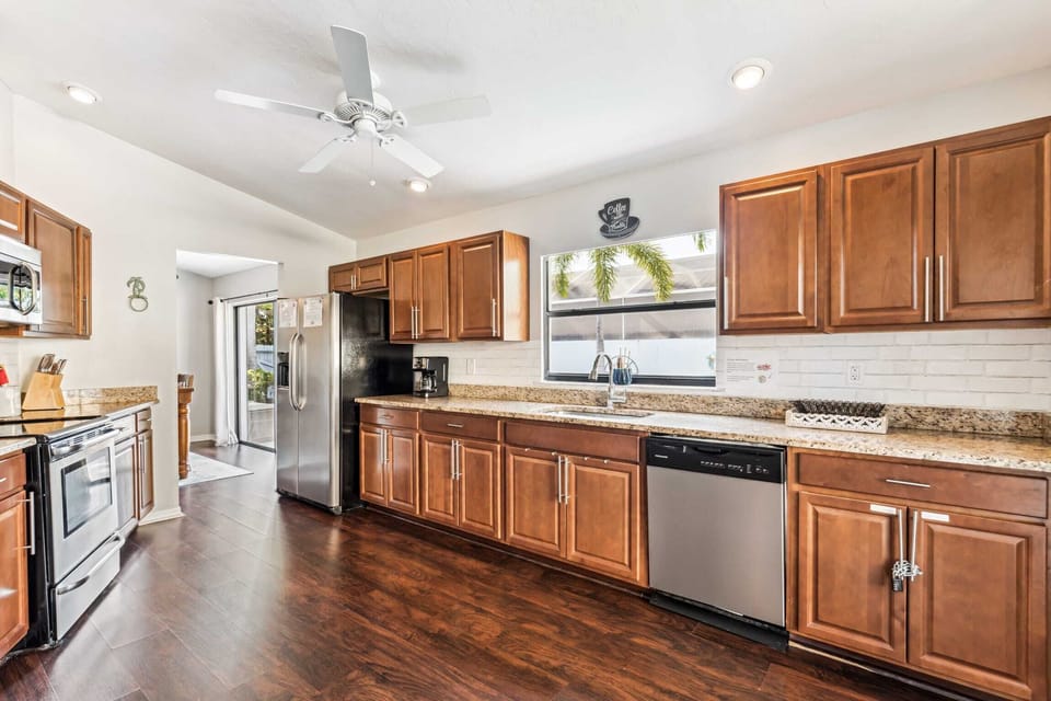 The long counter in the kitchen looks out towards the outdoor pool