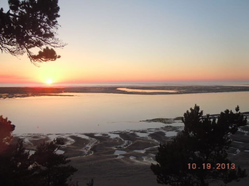 Looking west from deck at sunset with tide out