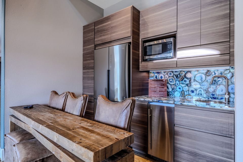 Separate kitchenette with a lighted quartz top, including a sonic ice maker.
