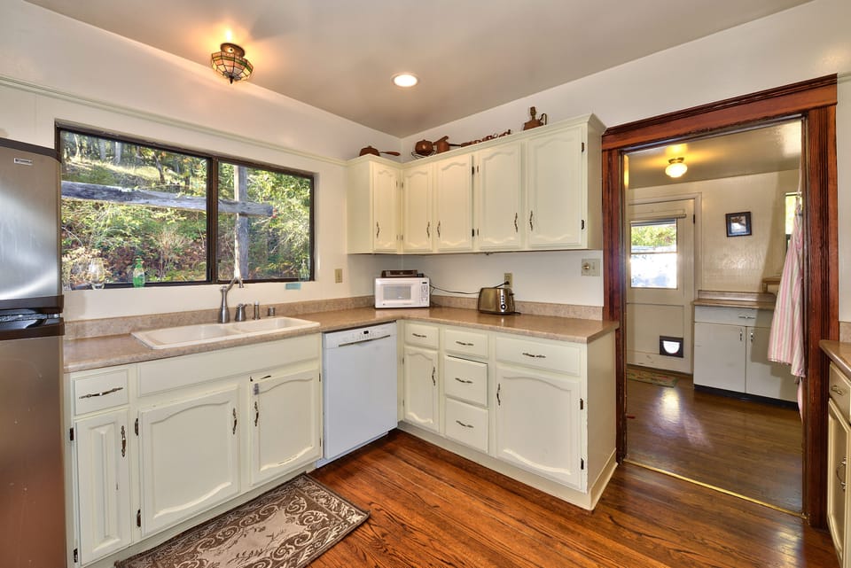 Kitchen with adjacent laundry room and view of yard