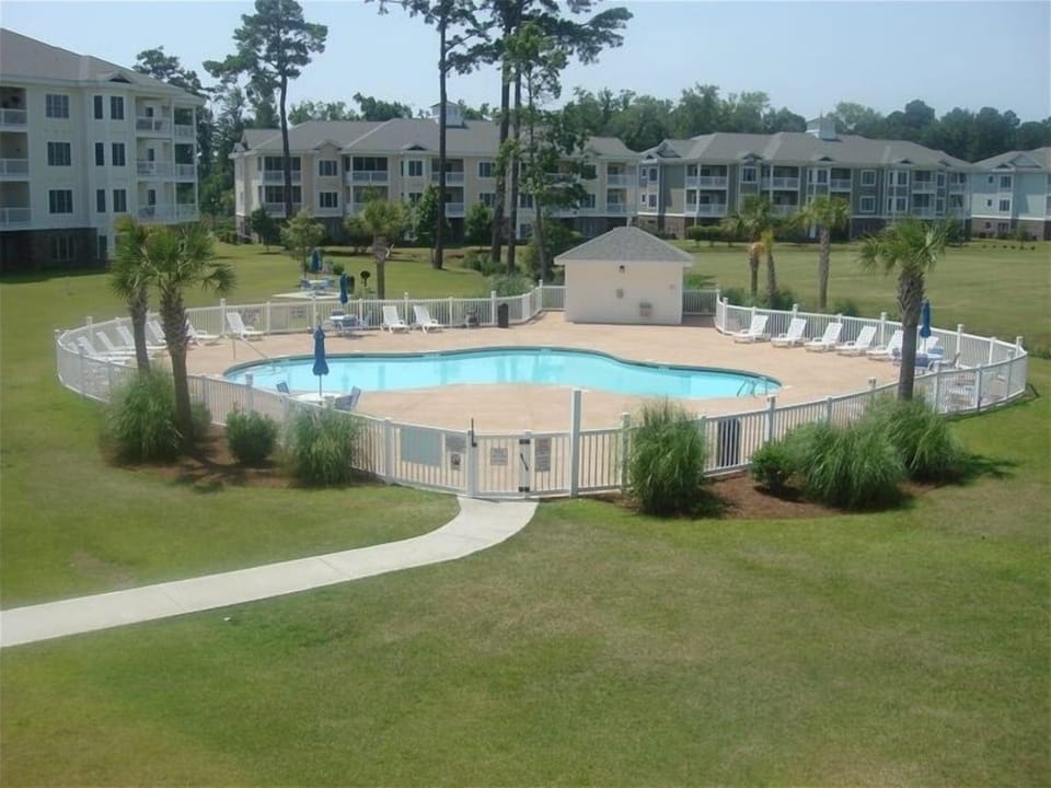 Balcony view-seating for four. 4 Pools with chairs, tables, shower & bathrooms.