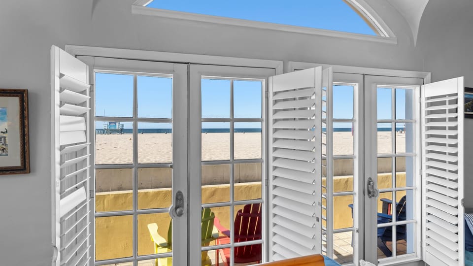 Great room opens up to west-facing patio steps from the beach