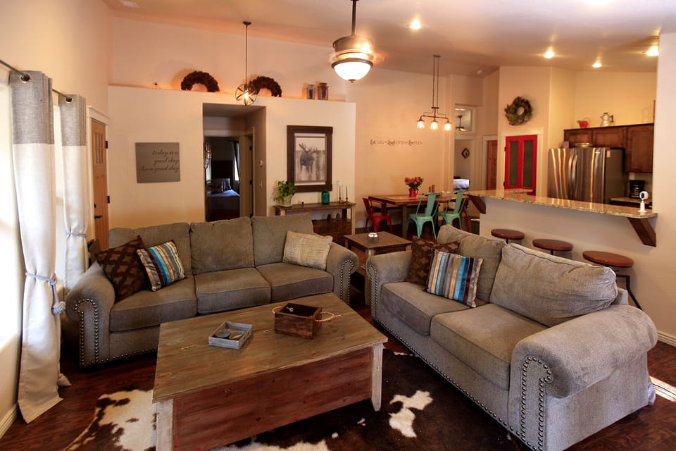 A cozy living area with comfy couches, cable TV, and a pull out couch