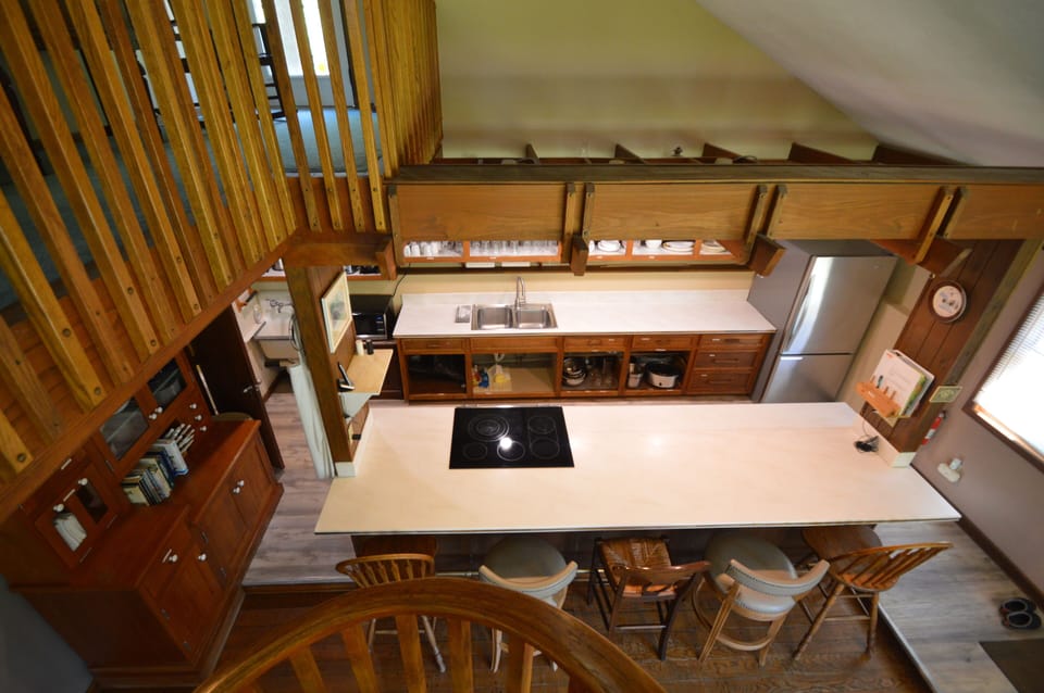 View from the loft to the kitchen and breakfast bar with seating.
