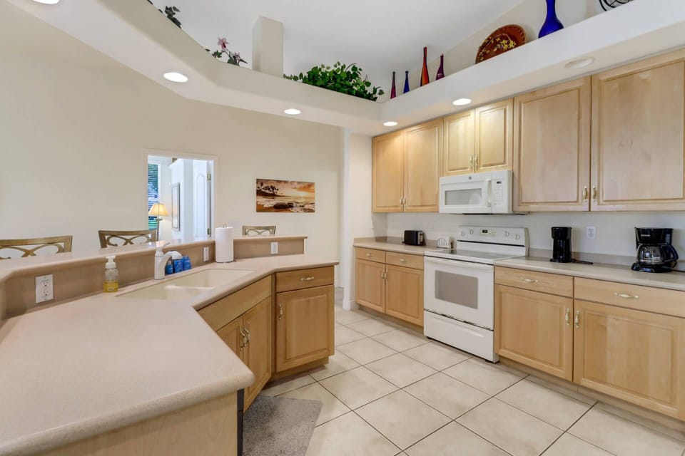 Like the rest of the home, the kitchen area enjoys high volume ceilings, and unbelievable views of the outdoor living space.