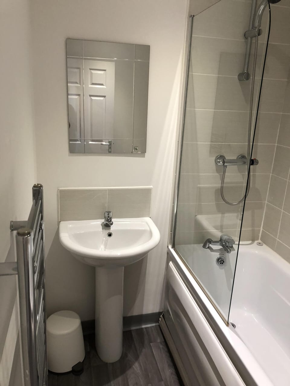 Bathroom showing newly fitted sink, towel rail and bath/shower
