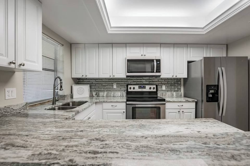 Fantasy Brown granite counters with three-dimensional glass brick backsplash