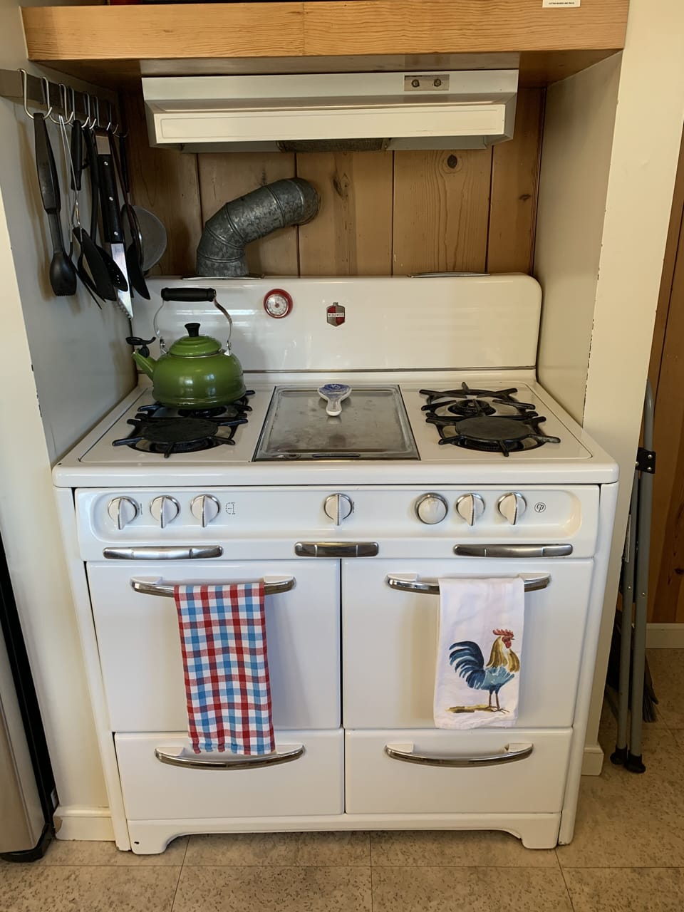 Classic Wedgewood stove with two ovens and griddle in the middle.