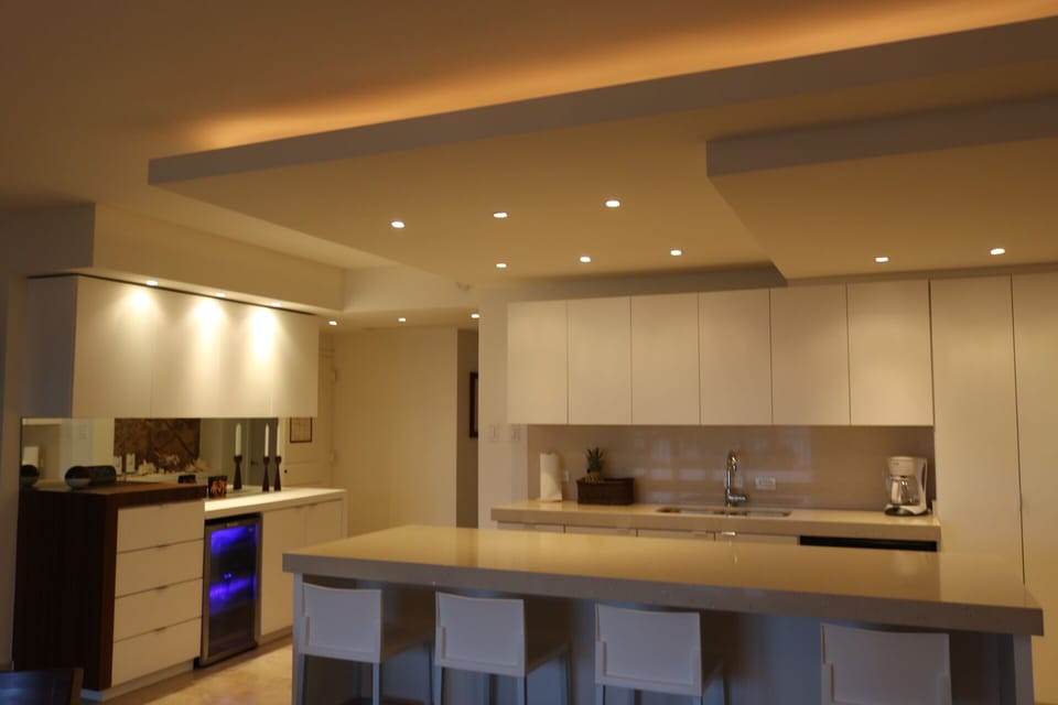 Kitchen,  dining area and bar with warm lighting in the evening