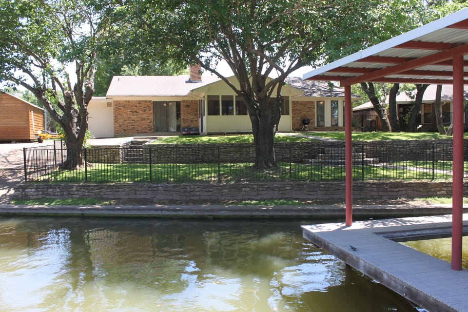 Photo from the dock swim platform looking at back yard.