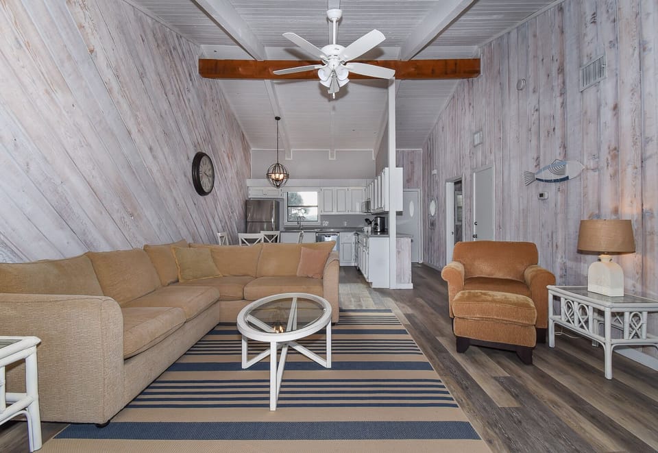 Living, dining and kitchen area with tan seating