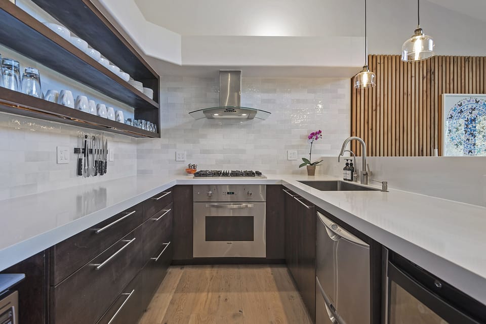 Open gourmet kitchen with Viking stove, double dishwasher and wine fridge