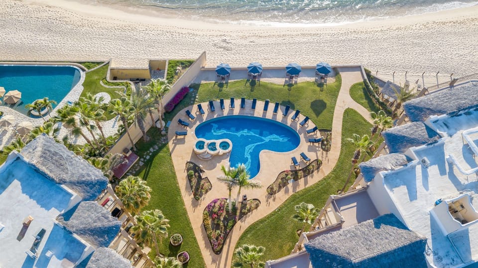 Las Olas is truly beach front, only steps away from the ocean.  The grounds are pristinely landscaped.  The pool area has loungers and umbrellas and there are more tables and chairs on the sandy area overlooking the ocean.