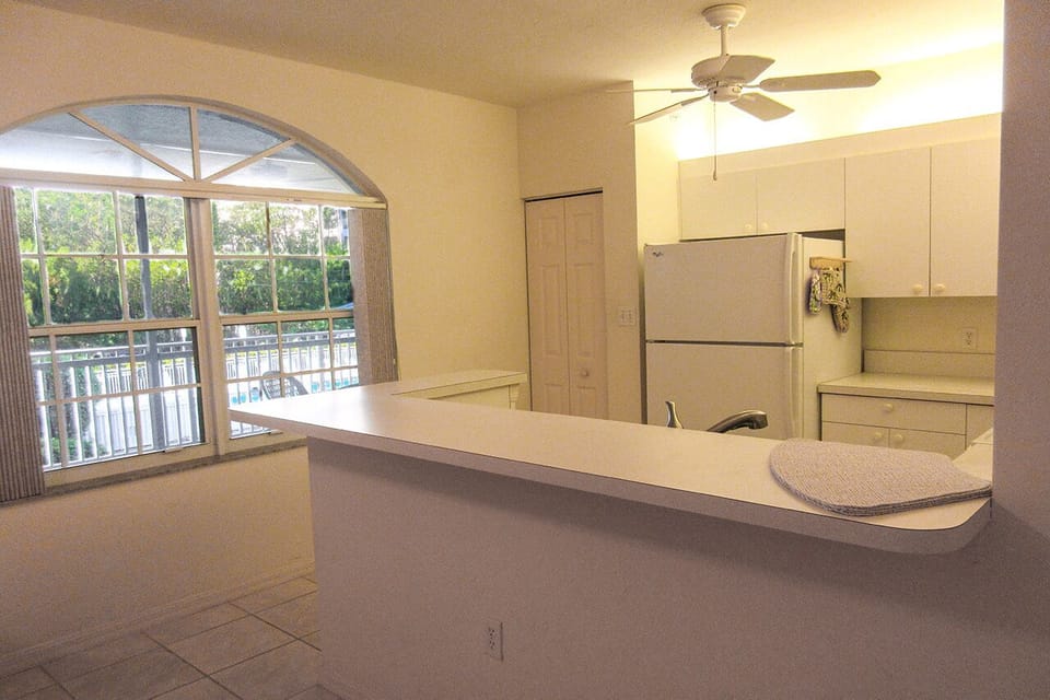 Bright, white, fully-equipped kitchen