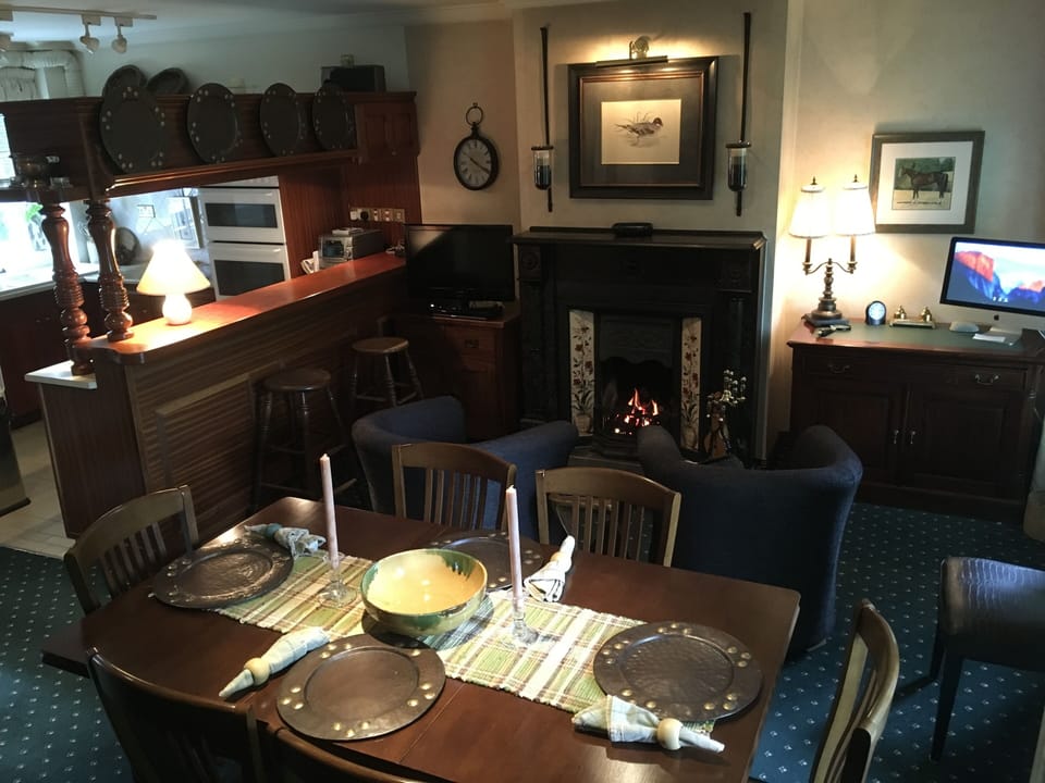 Lounge with 19th Century fire surround, Liscannor stone hearth and dining room.