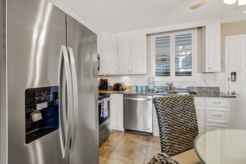 Cooking will be a pleasure in the new kitchen with granite counters, subway tile backsplash, farmhouse sink, and stainless appliances.