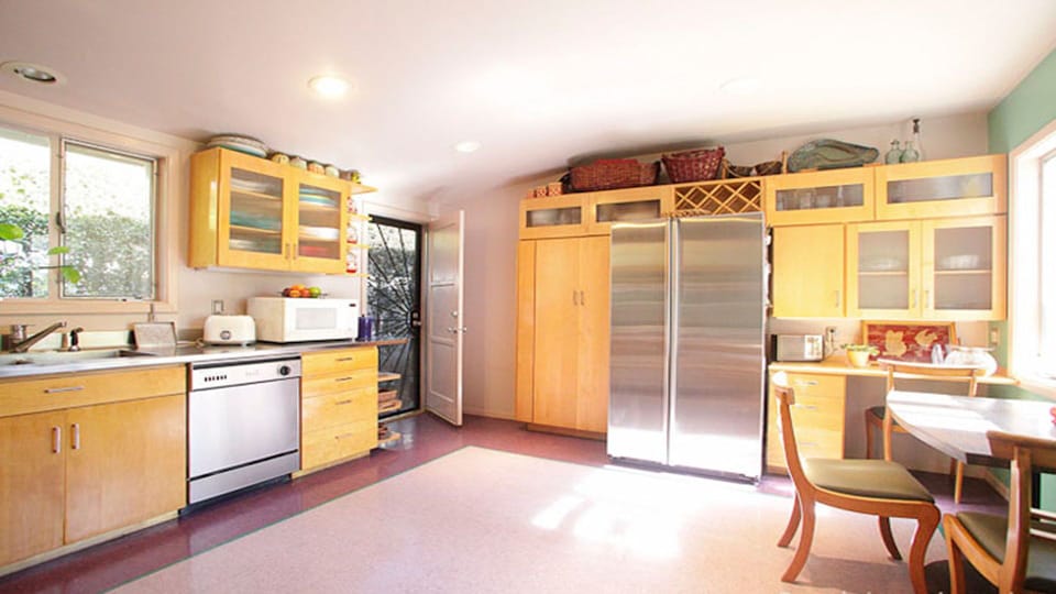 Kitchen with refrigerator, dishwasher, 6-burner stove, and breakfast nook.