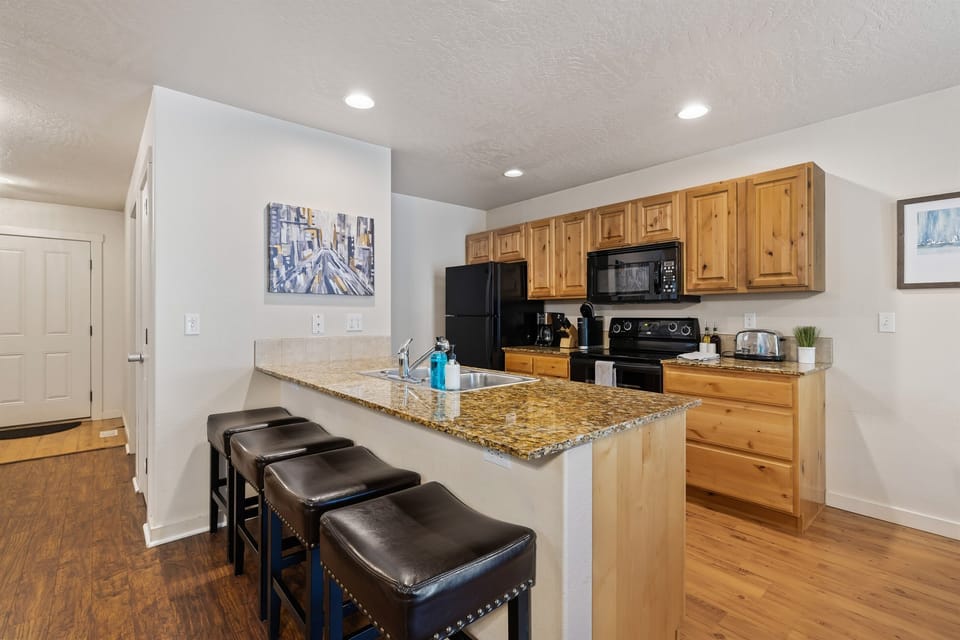 Enjoy cooking meals in with this fully stocked kitchen with granite counters and upgraded cabinets.