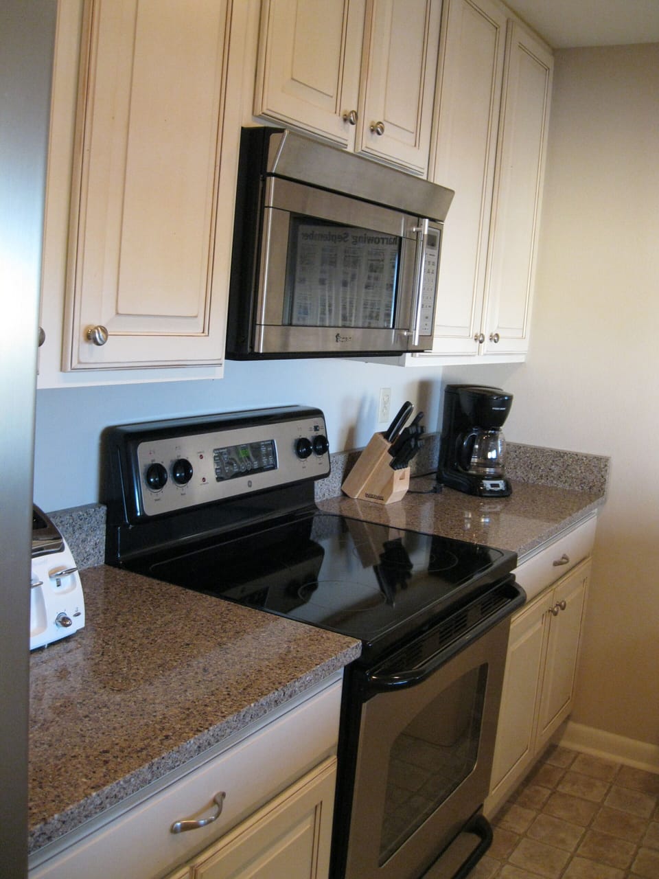 Galley Kitchen with stainless steel appliances, granite counter tops 