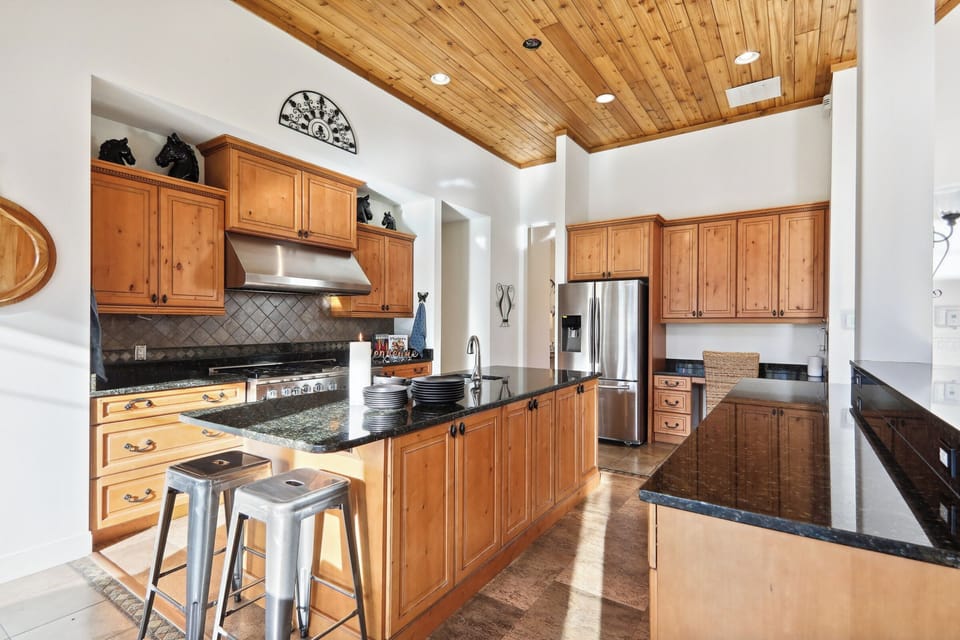 Massive kitchen granite counters, wood cabinets, cork floor, cedar-plank ceiling
