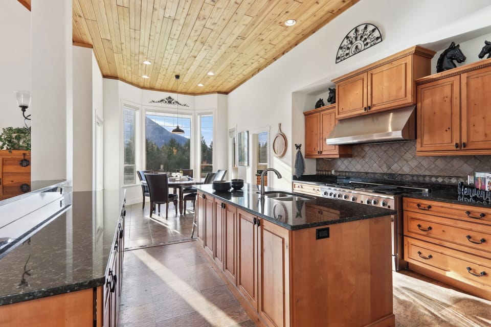 Massive Kitchen looking into Breakfast Nook. All Stainless steel appliances.