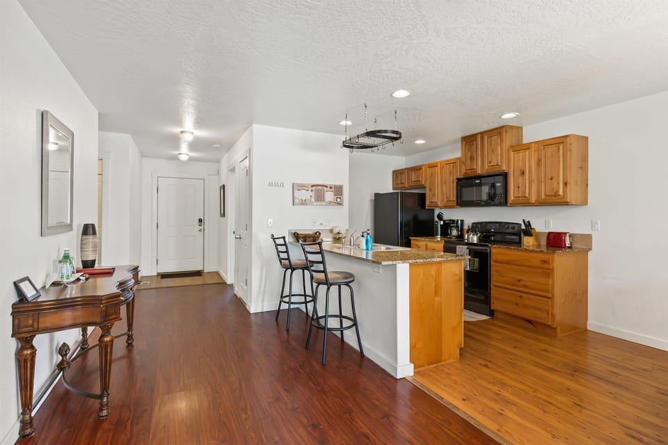 view of the spacious kitchen with upgraded cabinets, granite counters and fully stocked for cooking many meals!