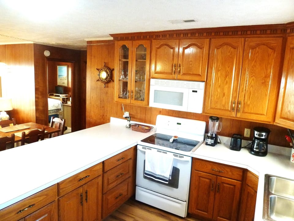 Custom built cabinets. Kitchen is well stocked for cooking all your meal!