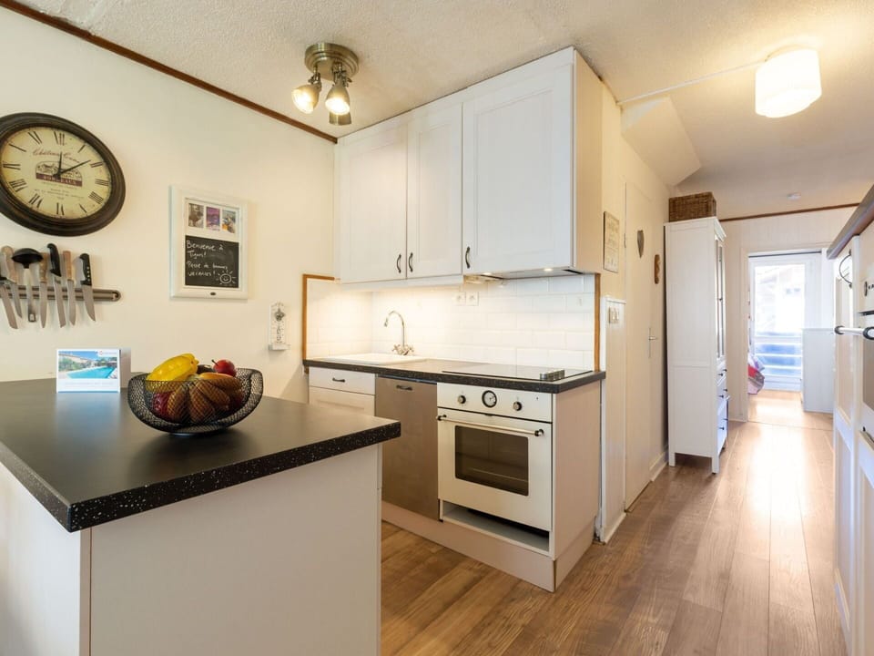 Cabinetry, Countertop, Wood, Kitchen, Kitchen Appliance, Interior Design, Kitchen Stove, Floor, Flooring, Clock