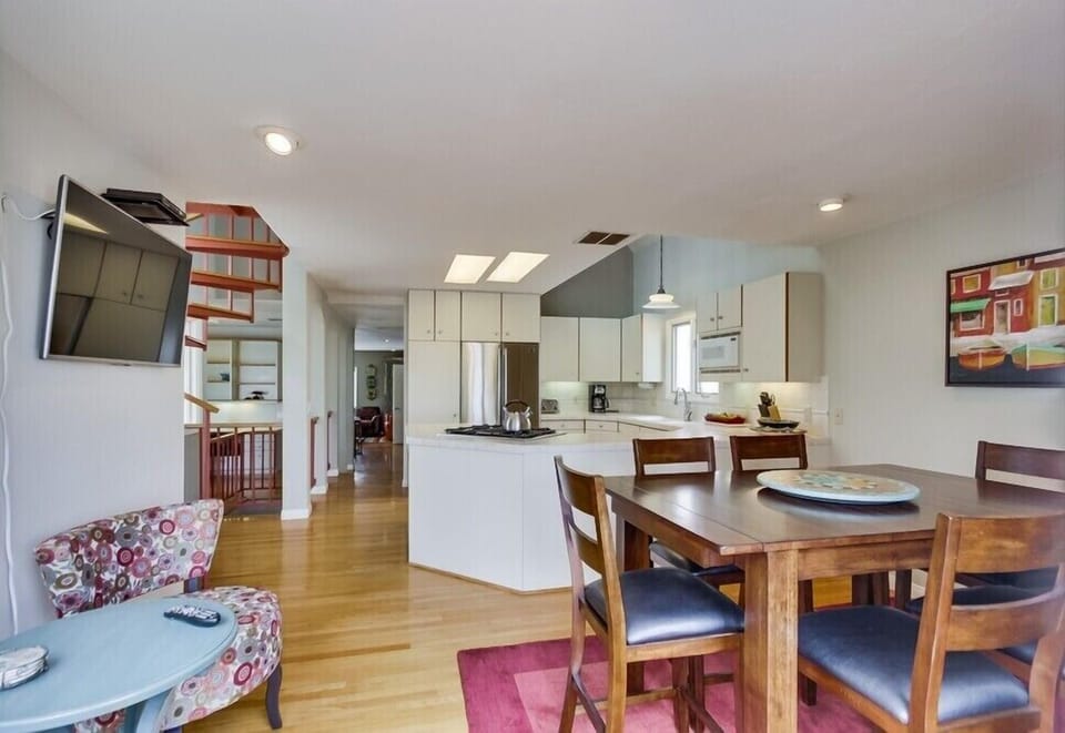 Dining, seating, kitchen area, view from main deck doorway.  Flat screen TV.