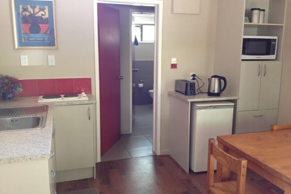 Kitchen area, through to bathroom, corridor between.