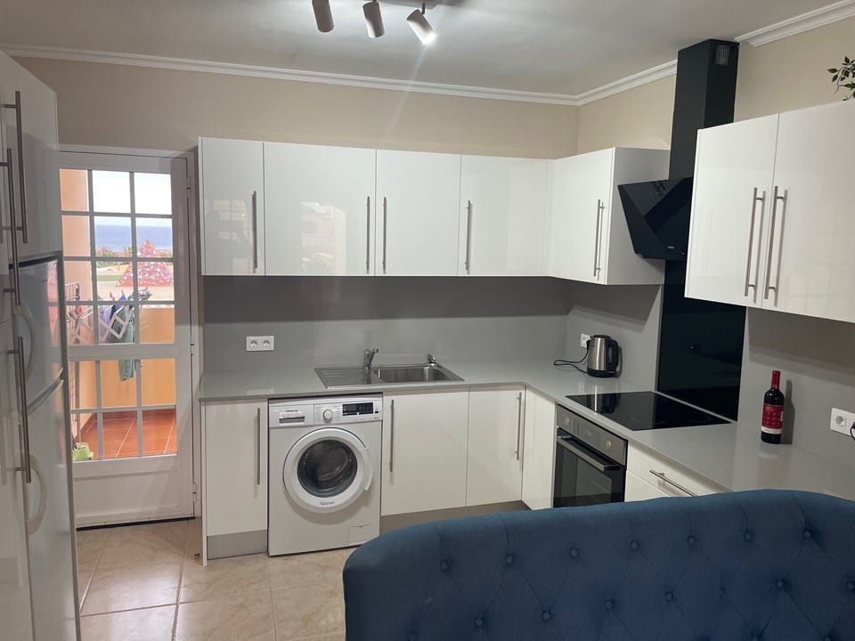 Kitchen includes washing machine and Dyson hoover.