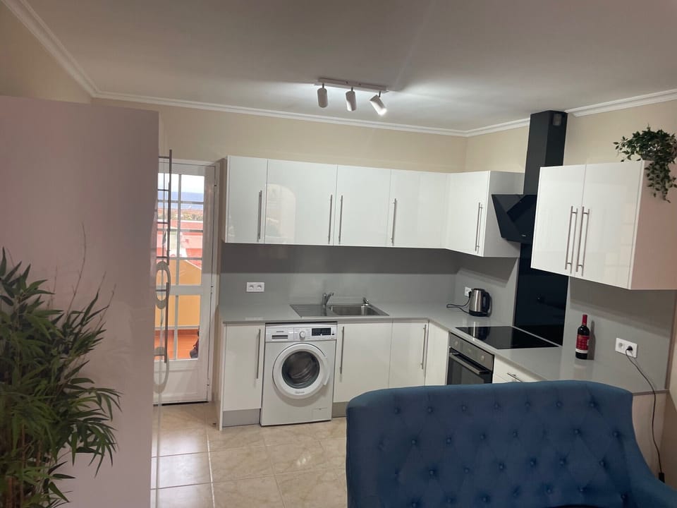 Modern kitchen equipped with microwave, oven & hob and fridge freezer.  
