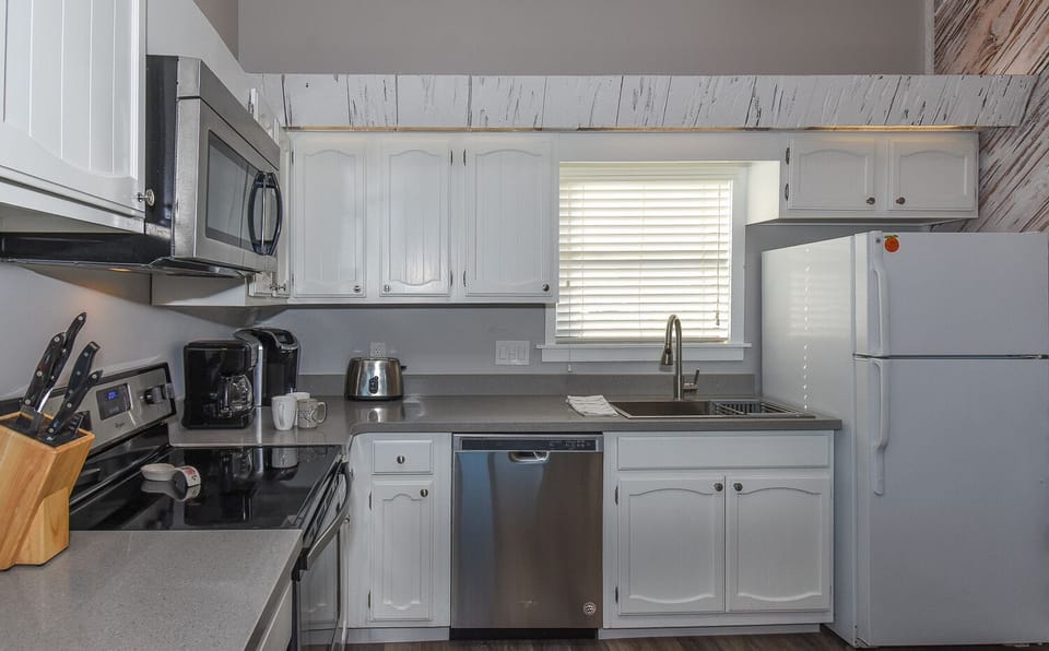 Kitchen with gray countertops and white cabinets