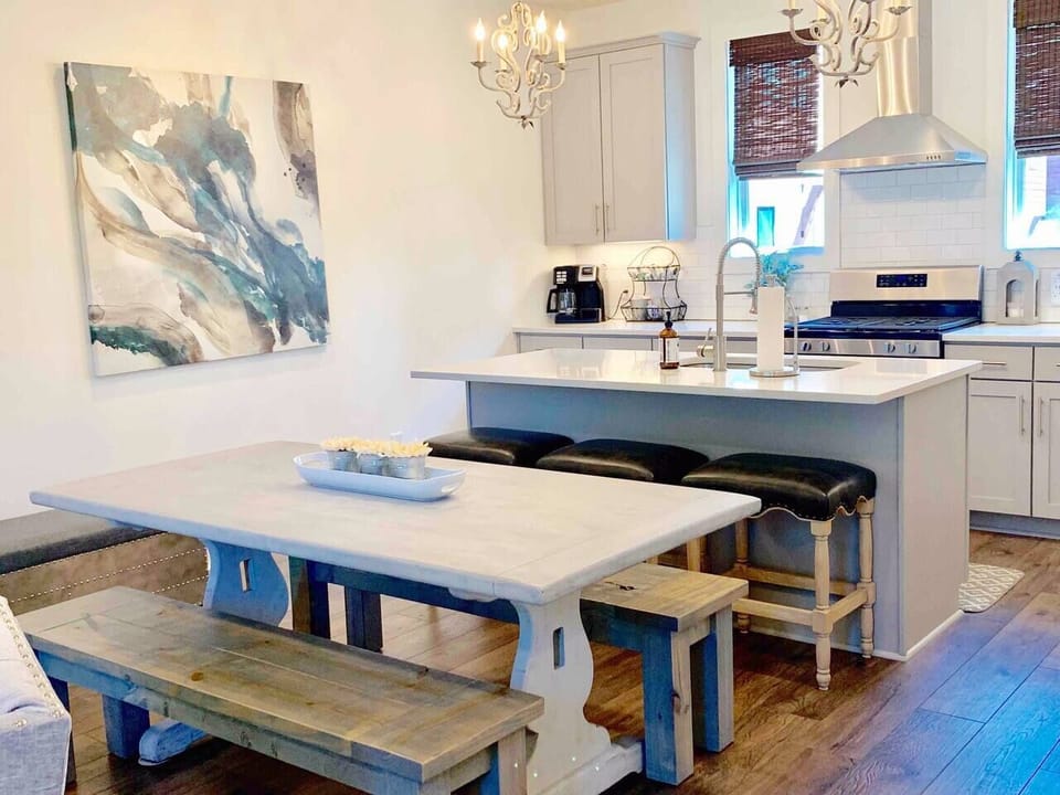 Lots of seating for your group in this open kitchen, dining and living room space.