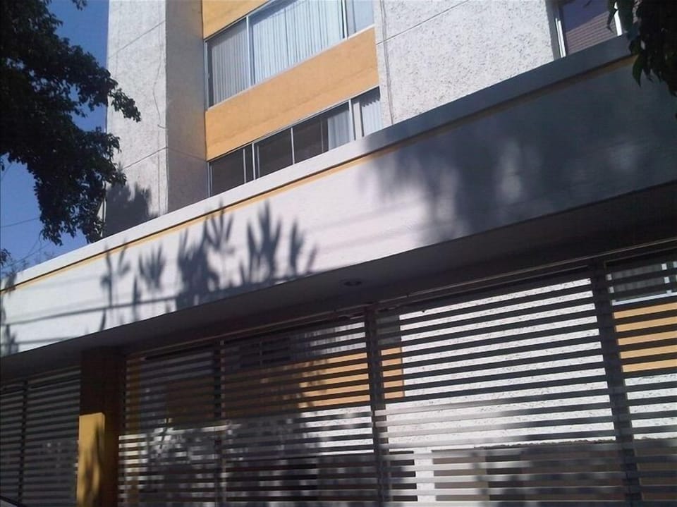 Outside picture of building and electric remote carport gate