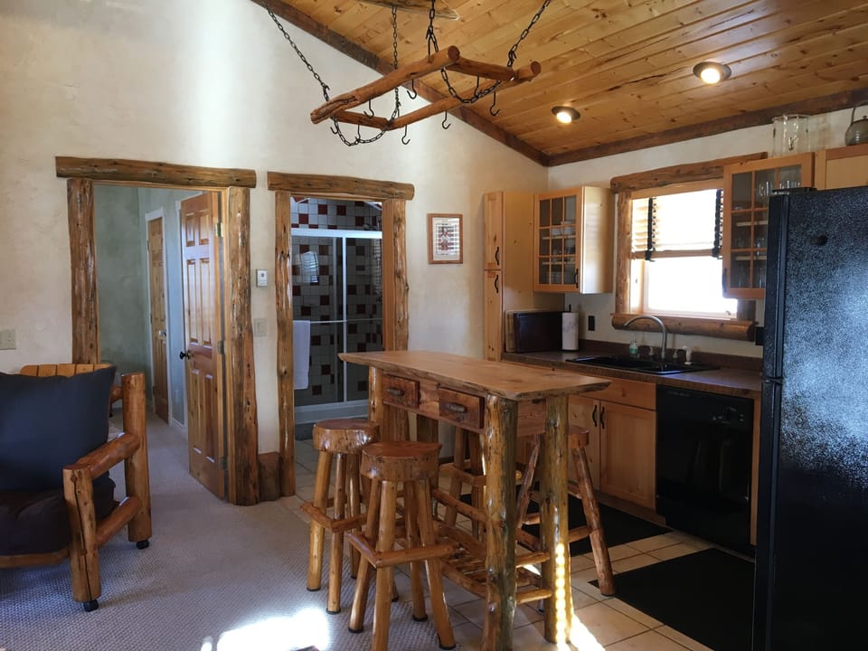 Full kitchen, bedroom and bathroom in background