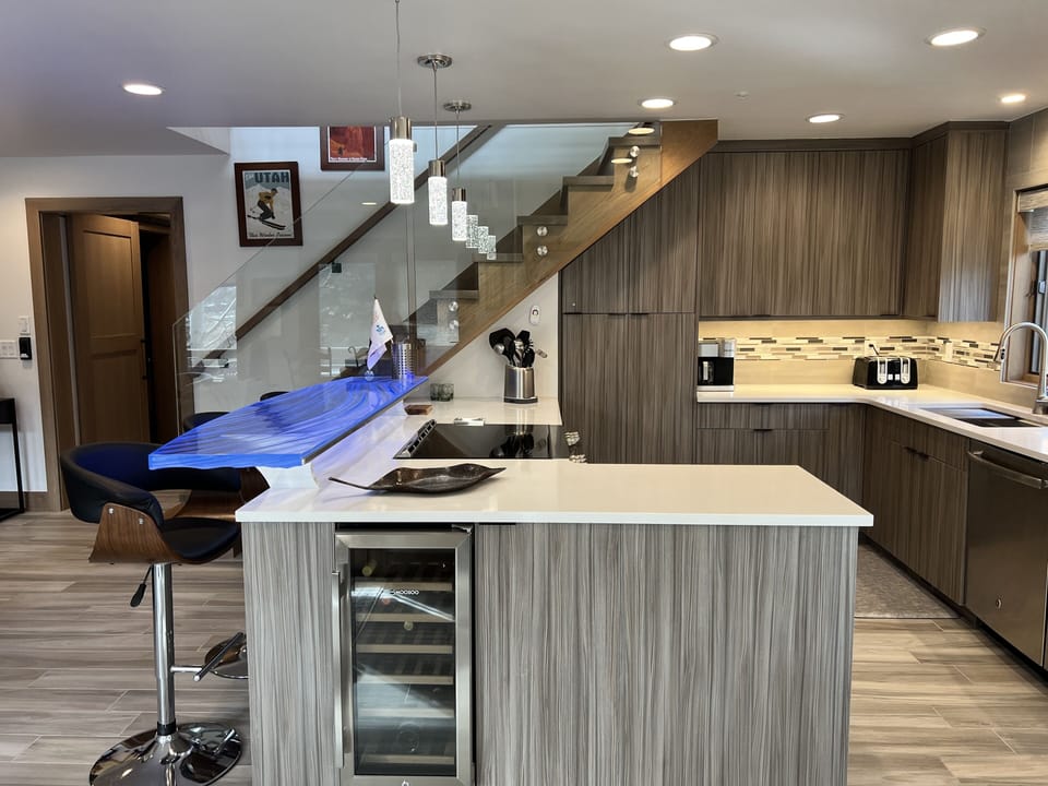 Kitchen island features a wine cooler.