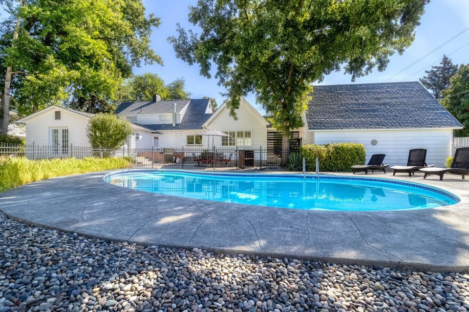 Your own backyard oasis with poolside seating + outdoor dining.
