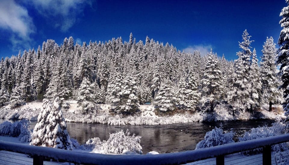Wintertime view of river and mountains from living/dining/den/kitchen