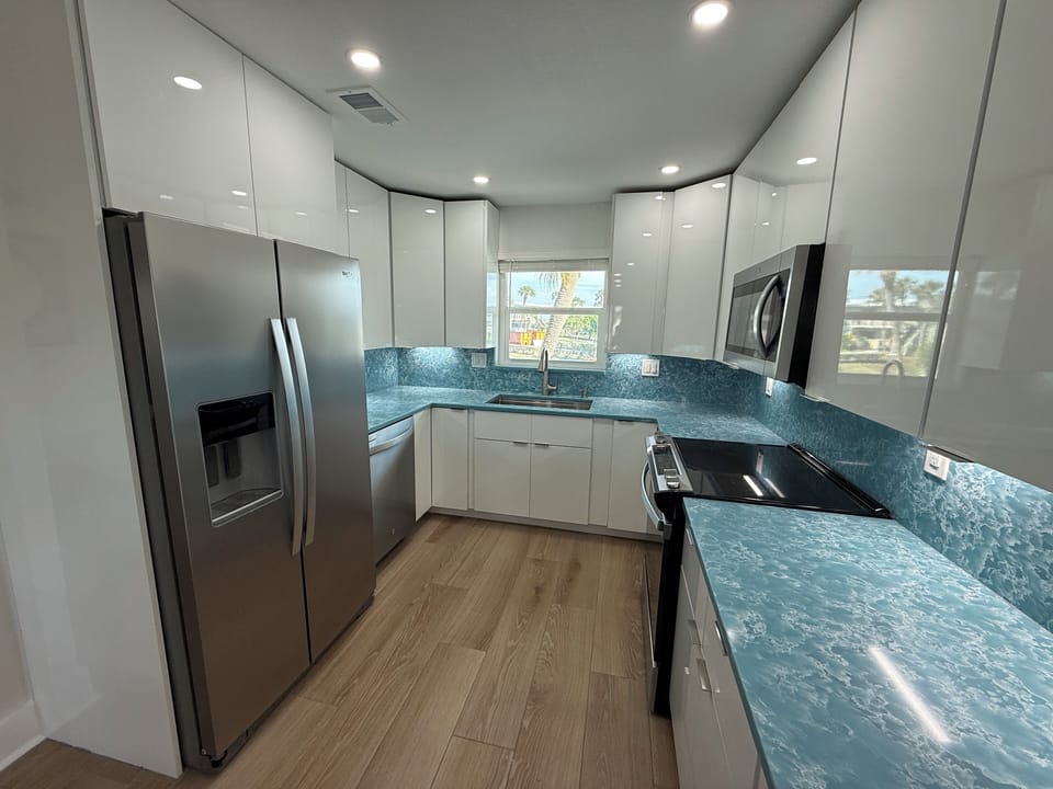 Beautiful, Large Kitchen with Quartz Counters and Sleek, Modern Cabinets