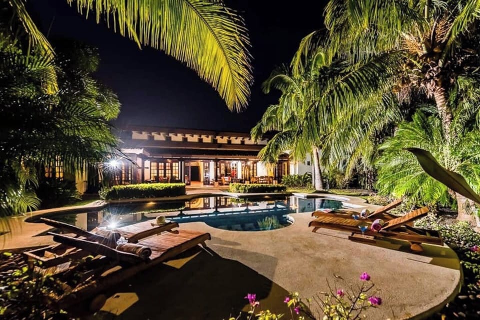 View of the pool and back porch at  night