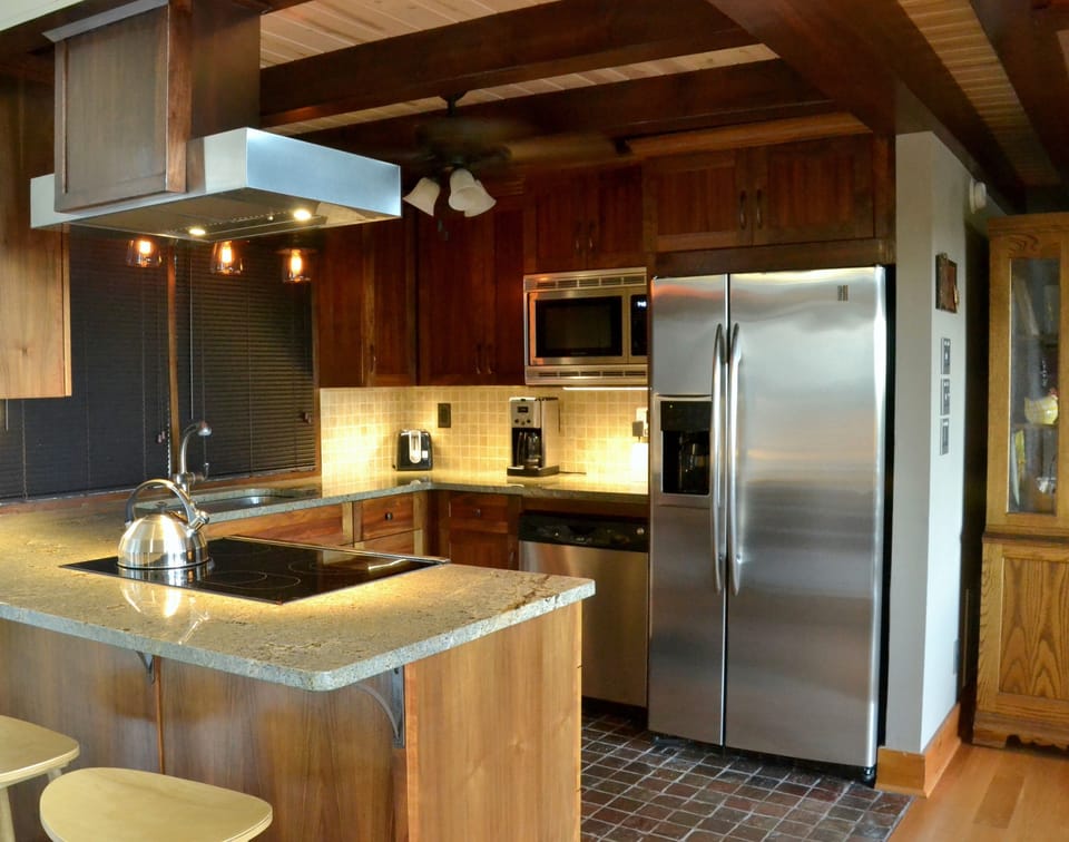 The Kitchen. Walnut cabinets, granite counters and stainless steel appliances