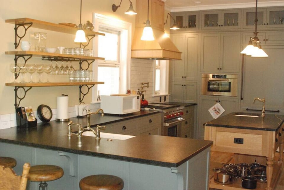 Fully equipped kitchen with stainless steel stove, oven, and microwave