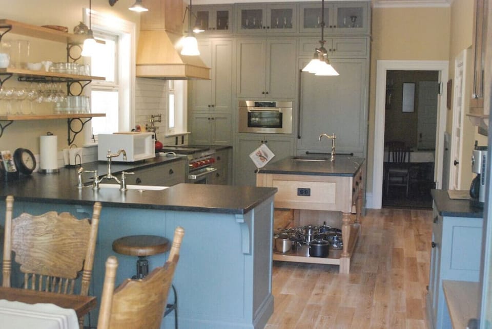 Fully equipped kitchen with stainless steel stove, oven, and microwave