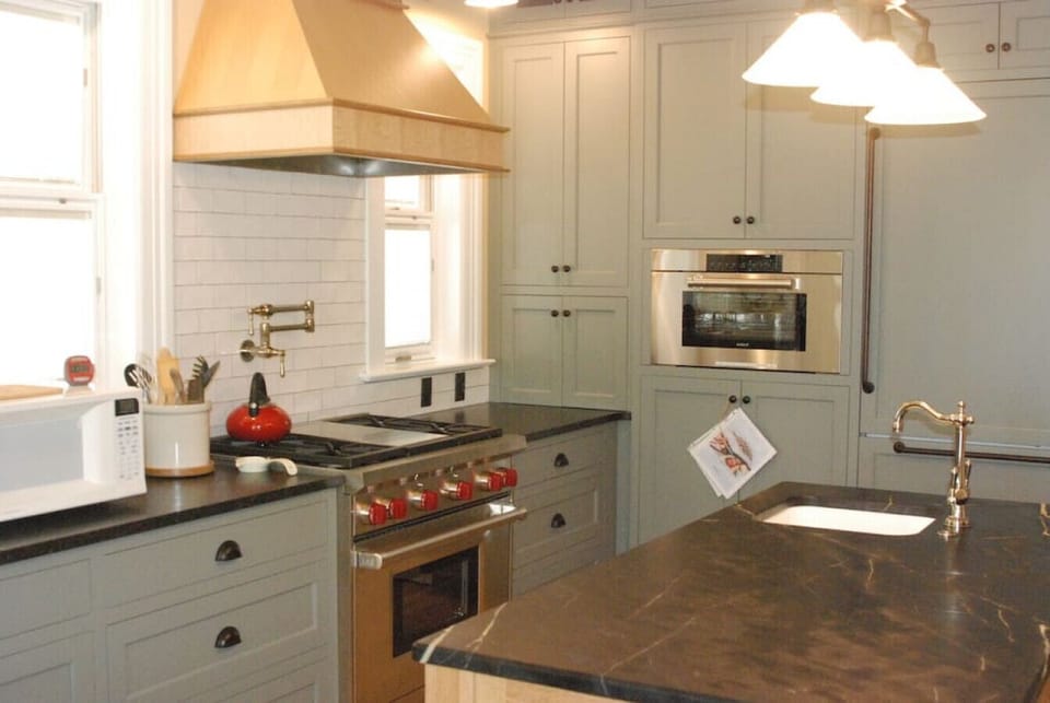 Fully equipped kitchen with stainless steel stove, oven, and microwave